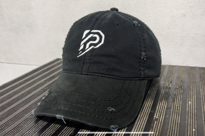 Black cap with a white logo on a textured surface
