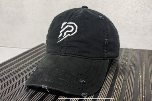 Black cap with a white logo on a textured surface